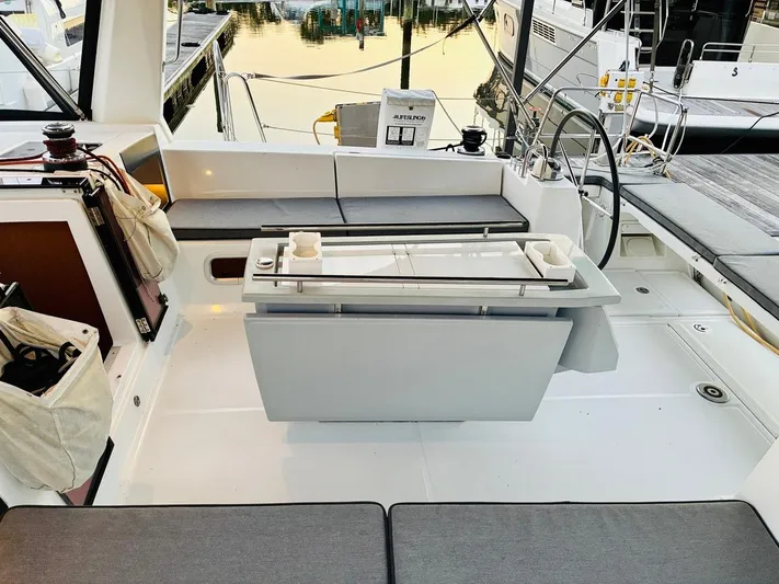  Yacht Photos Pics 2017 Beneteau Oceanis 45 yacht cockpit with seating, table, and steering wheel.