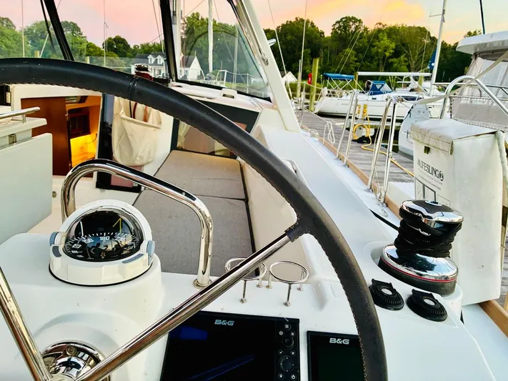  Yacht Photos Pics Cockpit of 2017 Beneteau Oceanis 45 sailboat with steering wheel and navigation instruments.