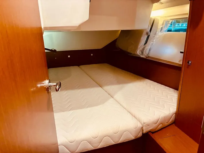  Yacht Photos Pics Cabin interior of 2017 Beneteau Oceanis 45 yacht with twin beds and wooden finish.