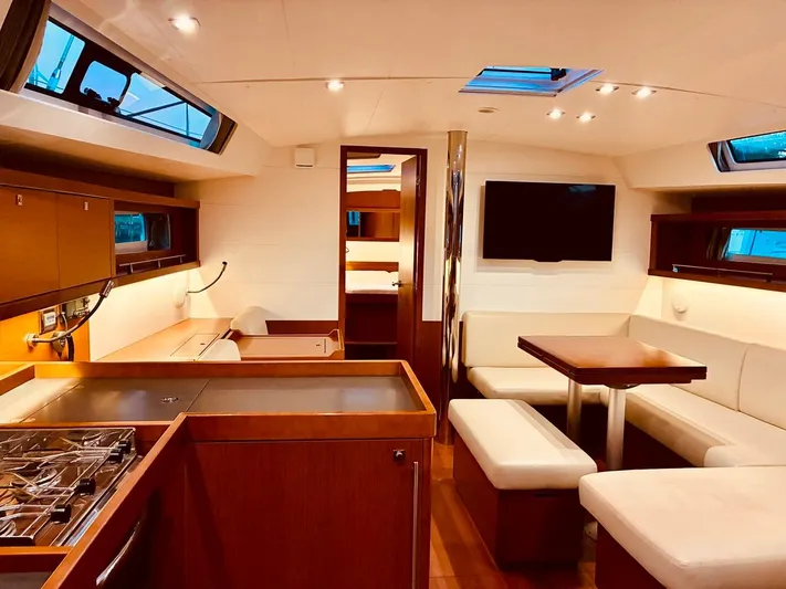  Yacht Photos Pics Luxurious interior of 2017 Beneteau Oceanis 45 yacht with modern kitchen and seating area.