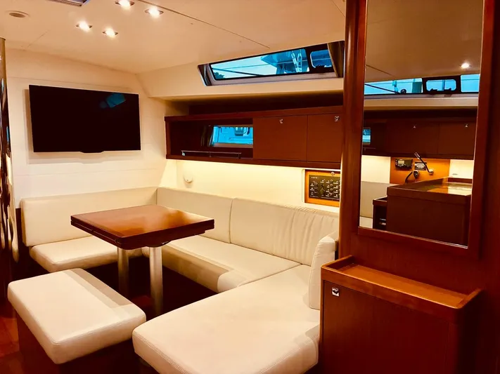  Yacht Photos Pics Luxurious interior of 2017 Beneteau Oceanis 45 yacht with modern seating and dining area.