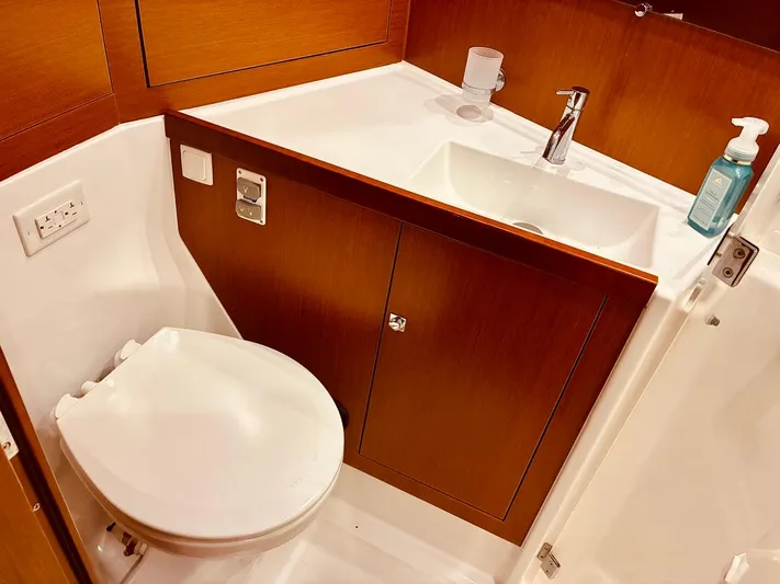  Yacht Photos Pics Bathroom interior of 2017 Beneteau Oceanis 45 yacht with sink and toilet.