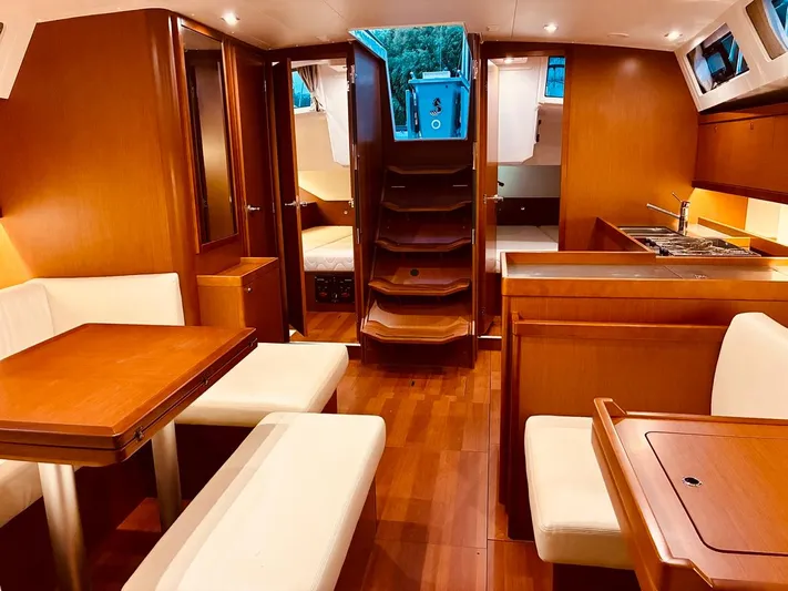  Yacht Photos Pics Interior of 2017 Beneteau Oceanis 45 yacht with wood finish and modern amenities.