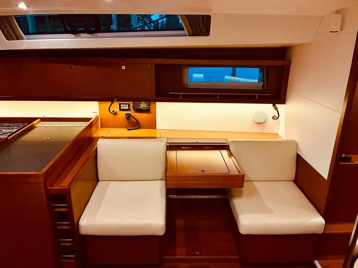  Yacht Photos Pics Interior of 2017 Beneteau Oceanis 45 yacht with cozy seating and wooden finishes.