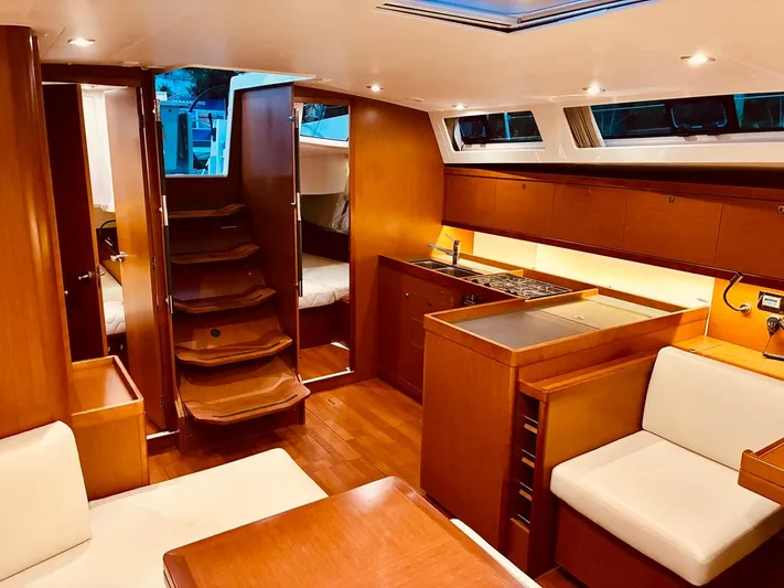  Yacht Photos Pics Luxurious interior of 2017 Beneteau Oceanis 45 yacht with modern kitchen and seating area.