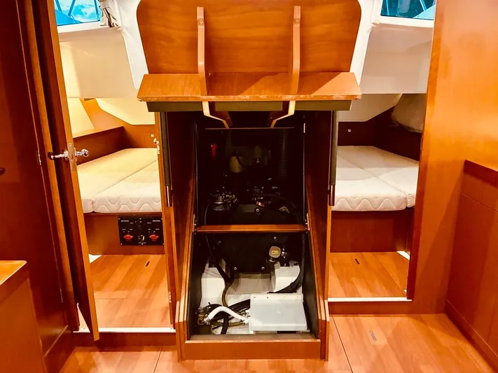  Yacht Photos Pics Engine compartment of 2017 Beneteau Oceanis 45 sailboat, showcasing interior wood finish.