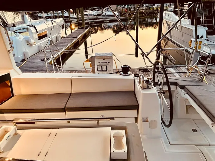  Yacht Photos Pics Cockpit of 2017 Beneteau Oceanis 45 yacht at marina, featuring seating and steering wheel.