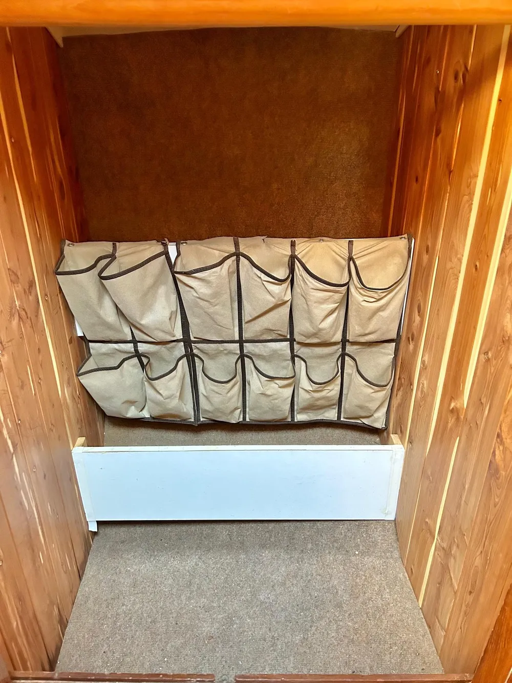 Storage area with hanging organizer in a 1975 Salar 40 boat interior.