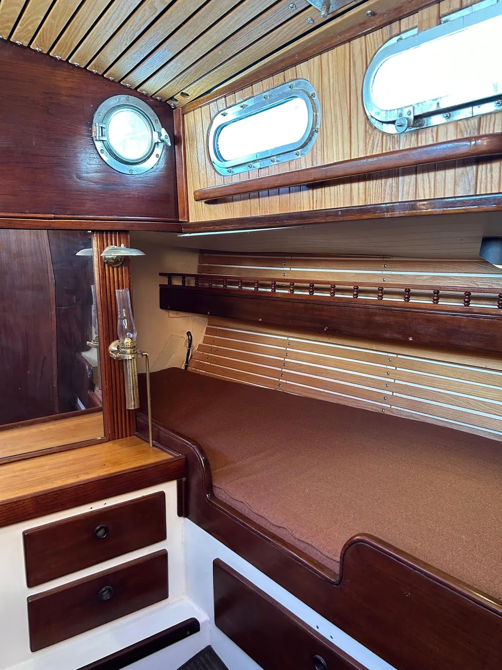 Interior of a 1975 Salar 40 sailboat with wooden paneling and cozy berth.