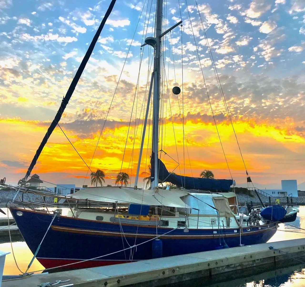 Salar 40 sailboat from 1975 docked at sunset with vibrant sky.