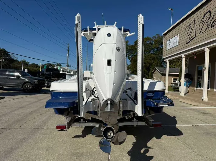 Black Label Marine Yacht Photos Pics Rear view of a 2026 Caymas 28 HB boat on a trailer.
