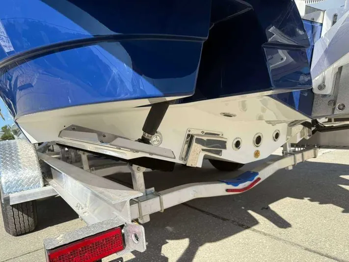 Black Label Marine Yacht Photos Pics Rear view of a 2026 Caymas 28 HB boat on a trailer.