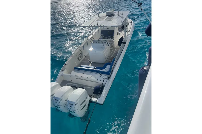 N/a Yacht Photos Pics 2014 Midnight Express 37 EXK boat on clear blue water, featuring triple Mercury engines.