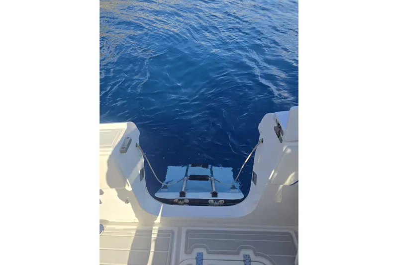 N/a Yacht Photos Pics Rear view of 2014 Midnight Express 37 EXK boat with swim platform on blue water.