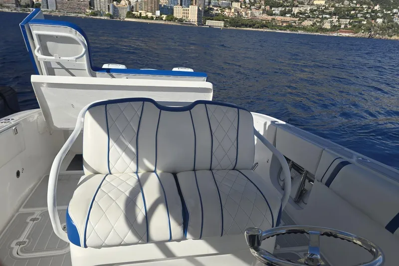 N/a Yacht Photos Pics Luxurious seating on 2014 Midnight Express 37 EXK boat with ocean and cityscape backdrop.