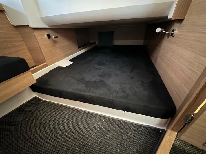 Mdr #187 In Stock Yacht Photos Pics 2023 Nimbus T11 cabin interior with black mattress and wooden finish.