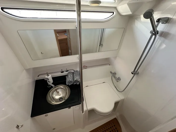 Mdr #187 In Stock Yacht Photos Pics 2023 Nimbus T11 bathroom with modern fixtures, stainless steel sink, and shower area.