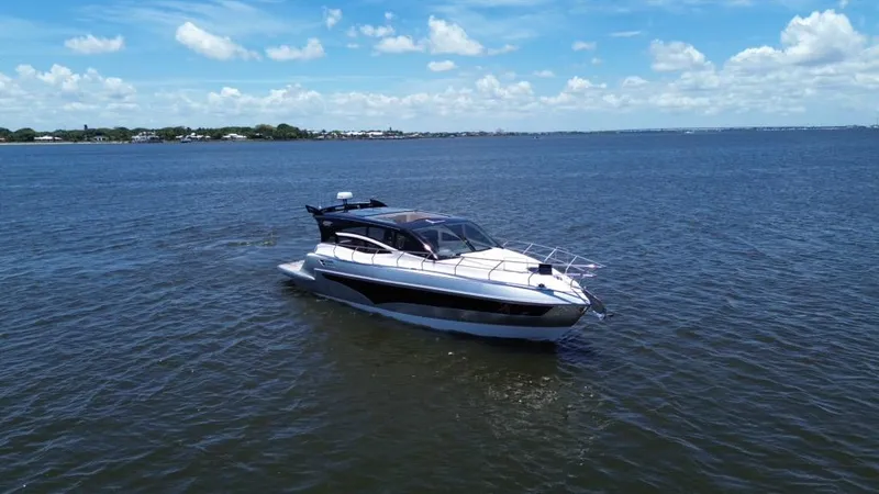  Yacht Photos Pics Luxury yacht Real 40 HT 2025 cruising on open water under a clear blue sky.