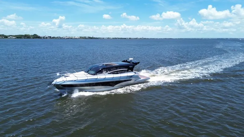  Yacht Photos Pics Luxury yacht Real 40 HT cruising on open water under a clear blue sky.