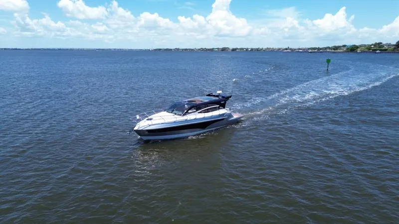  Yacht Photos Pics Luxury yacht Real 40 HT cruising on open water under a clear blue sky.