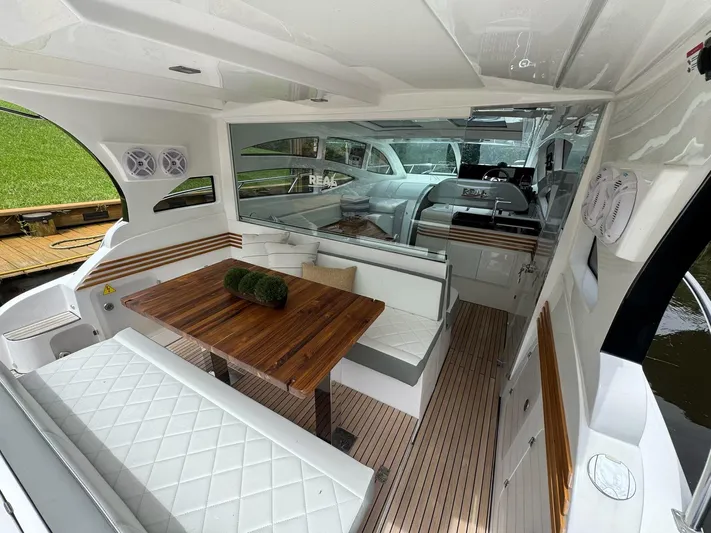  Yacht Photos Pics 2025 Real 40 HT Luxury yacht interior with elegant seating and wooden table.