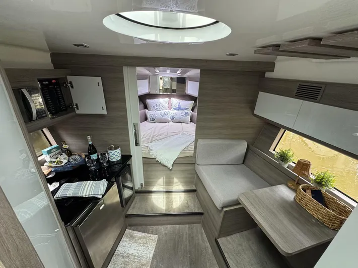  Yacht Photos Pics Luxurious interior of 2025 Real 40 HT yacht, featuring modern kitchen and cozy bedroom.