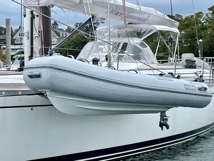 Disco Lemonade Yacht Photos Pics Nautor Swan 68 yacht from 1992 with a dinghy attached, docked at a marina.