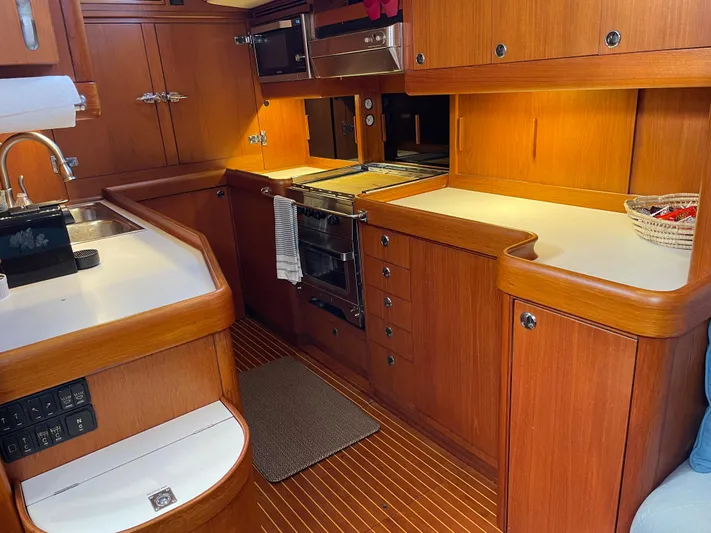 Disco Lemonade Yacht Photos Pics Interior kitchen of 1992 Nautor Swan 68 yacht with wooden cabinetry and modern appliances.