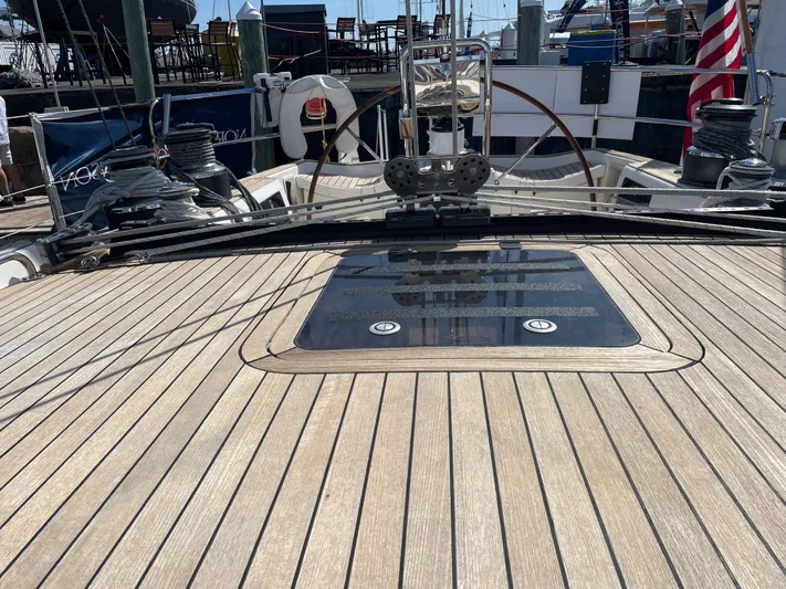 Disco Lemonade Yacht Photos Pics Nautor Swan 68 (1992) yacht deck with wooden finish and steering wheel.