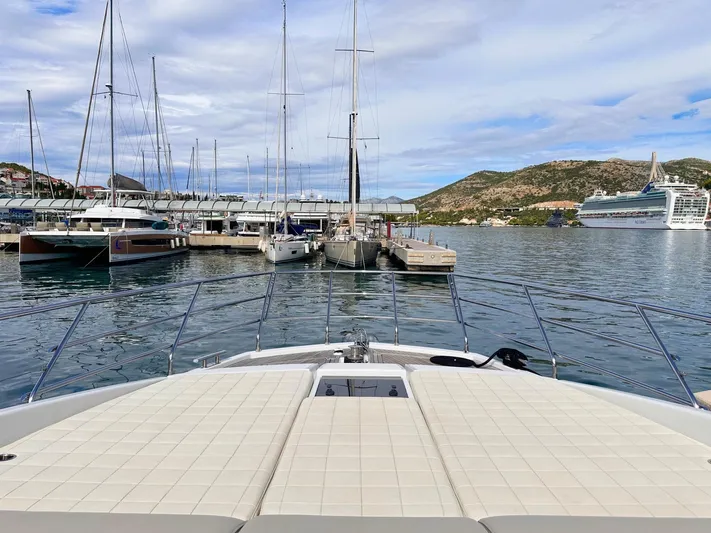Tamara II Yacht Photos Pics Azimut 66 FLY 2018 yacht docked in scenic marina with hills and cruise ship.