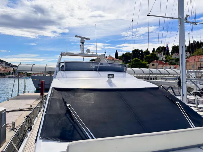 Tamara II Yacht Photos Pics Azimut 66 FLY 2018 yacht docked at a marina under a partly cloudy sky.