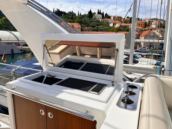 Tamara II Yacht Photos Pics Outdoor kitchen on 2018 Azimut 66 FLY yacht with grill and cup holders.