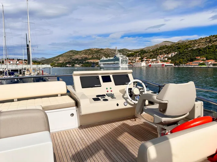 Tamara II Yacht Photos Pics Flybridge of 2018 Azimut 66 FLY yacht with scenic coastal view.