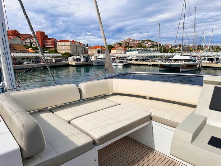 Tamara II Yacht Photos Pics Luxurious seating on 2018 Azimut 66 FLY yacht, docked in scenic marina.