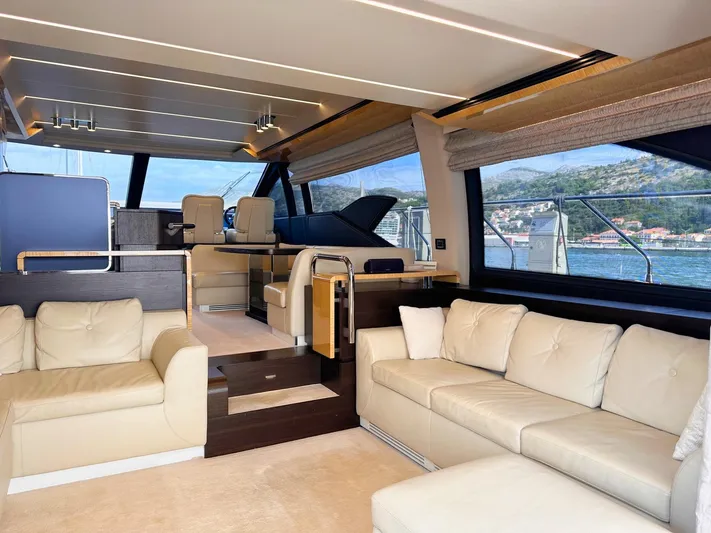 Tamara II Yacht Photos Pics Luxurious interior of 2018 Azimut 66 FLY yacht with beige leather seating and panoramic windows.