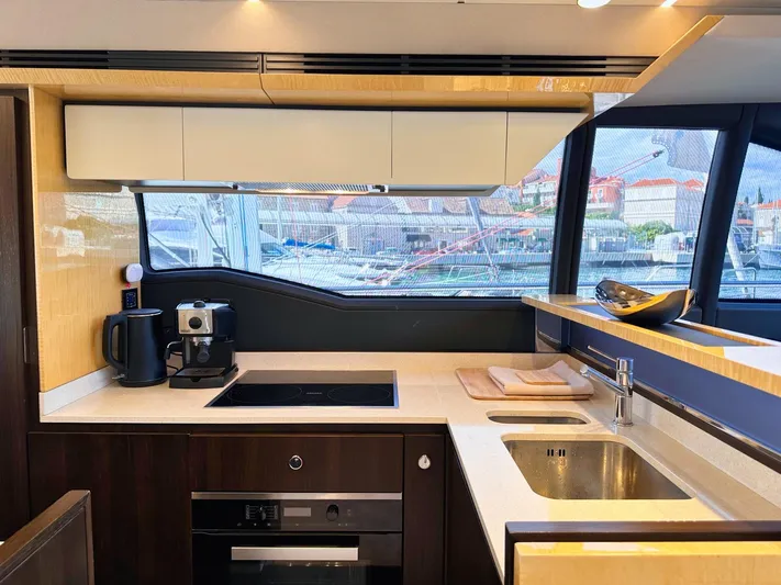 Tamara II Yacht Photos Pics Luxurious kitchen interior of 2018 Azimut 66 FLY yacht with modern appliances and sleek design.