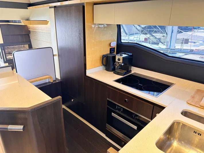 Tamara II Yacht Photos Pics Luxurious kitchen interior of 2018 Azimut 66 FLY yacht with modern appliances and sleek design.
