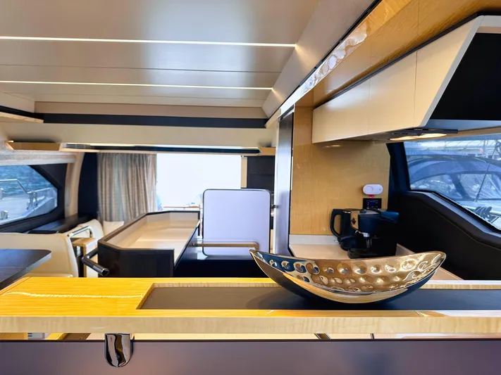 Tamara II Yacht Photos Pics Luxurious interior of 2018 Azimut 66 FLY yacht with modern kitchen and elegant decor.