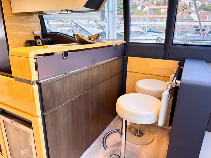 Tamara II Yacht Photos Pics Luxurious interior of 2018 Azimut 66 FLY yacht with modern bar and seating.