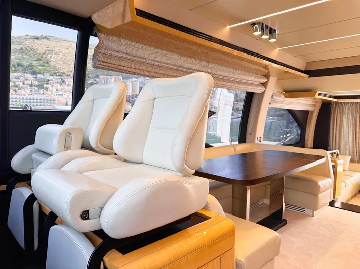 Tamara II Yacht Photos Pics Luxurious interior of 2018 Azimut 66 FLY yacht with plush seating and elegant dining area.