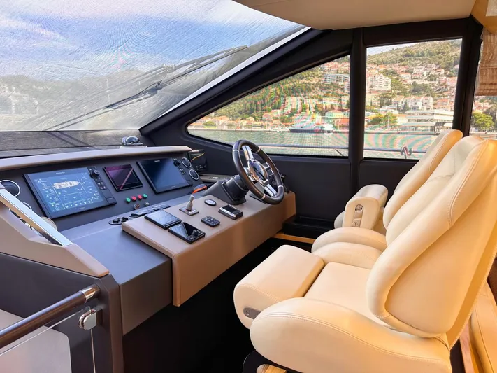 Tamara II Yacht Photos Pics Luxurious 2018 Azimut 66 FLY yacht cockpit with modern controls and plush seating.