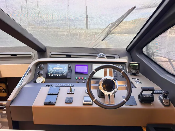 Tamara II Yacht Photos Pics Cockpit of 2018 Azimut 66 FLY yacht with modern navigation controls and steering wheel.