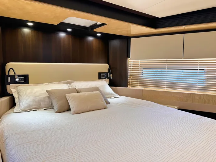 Tamara II Yacht Photos Pics Luxurious bedroom interior of 2018 Azimut 66 FLY yacht with modern design and cozy bedding.