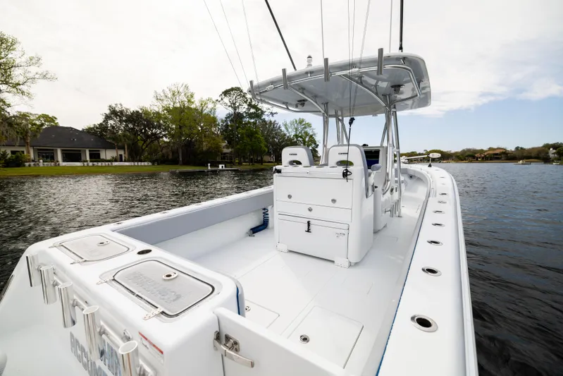  Yacht Photos Pics 2022 Contender 35ST boat on calm water, showcasing spacious deck and sleek design.