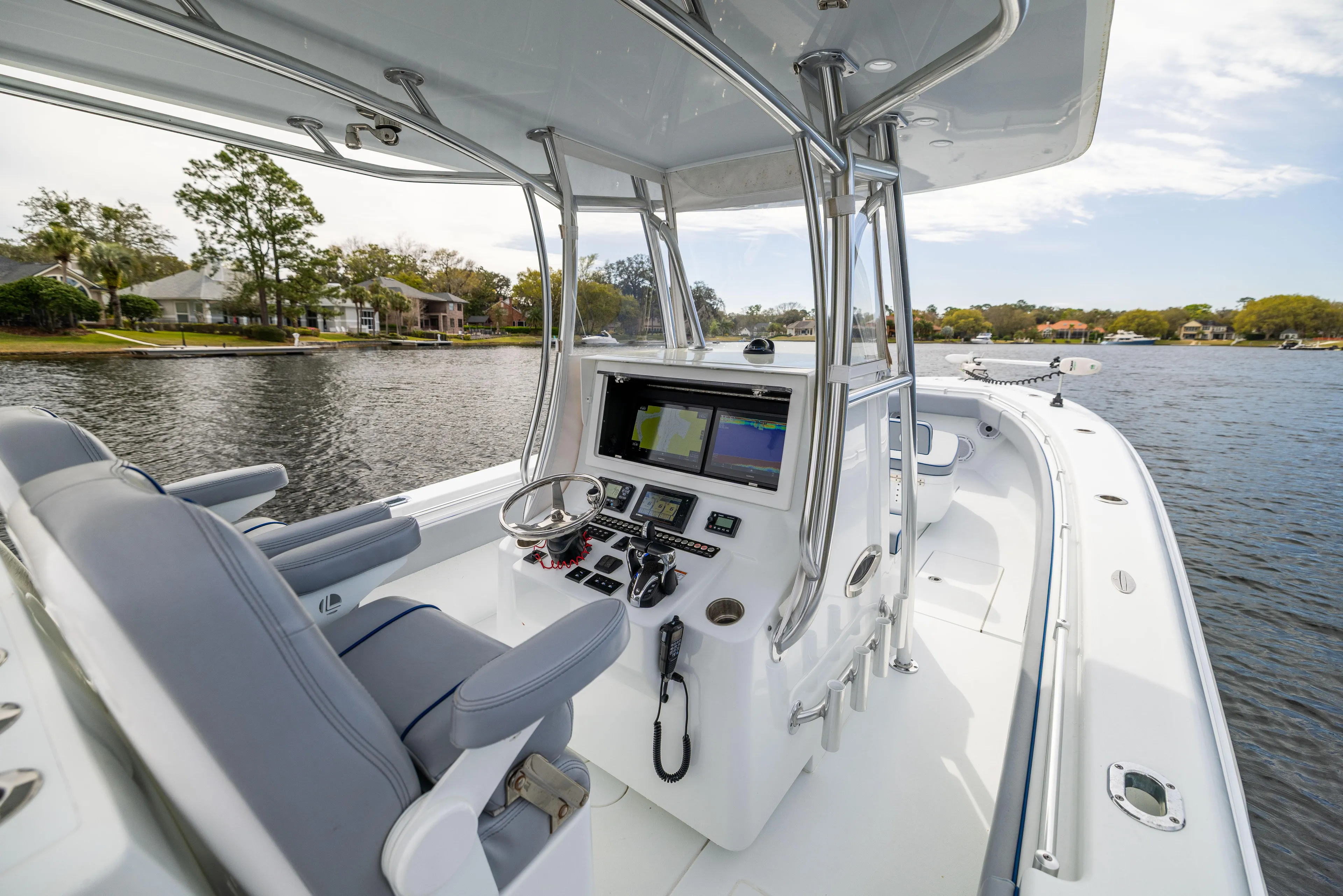  Yacht Photos Pics 2022 Contender 35ST boat interior with modern helm and navigation system on a calm lake.