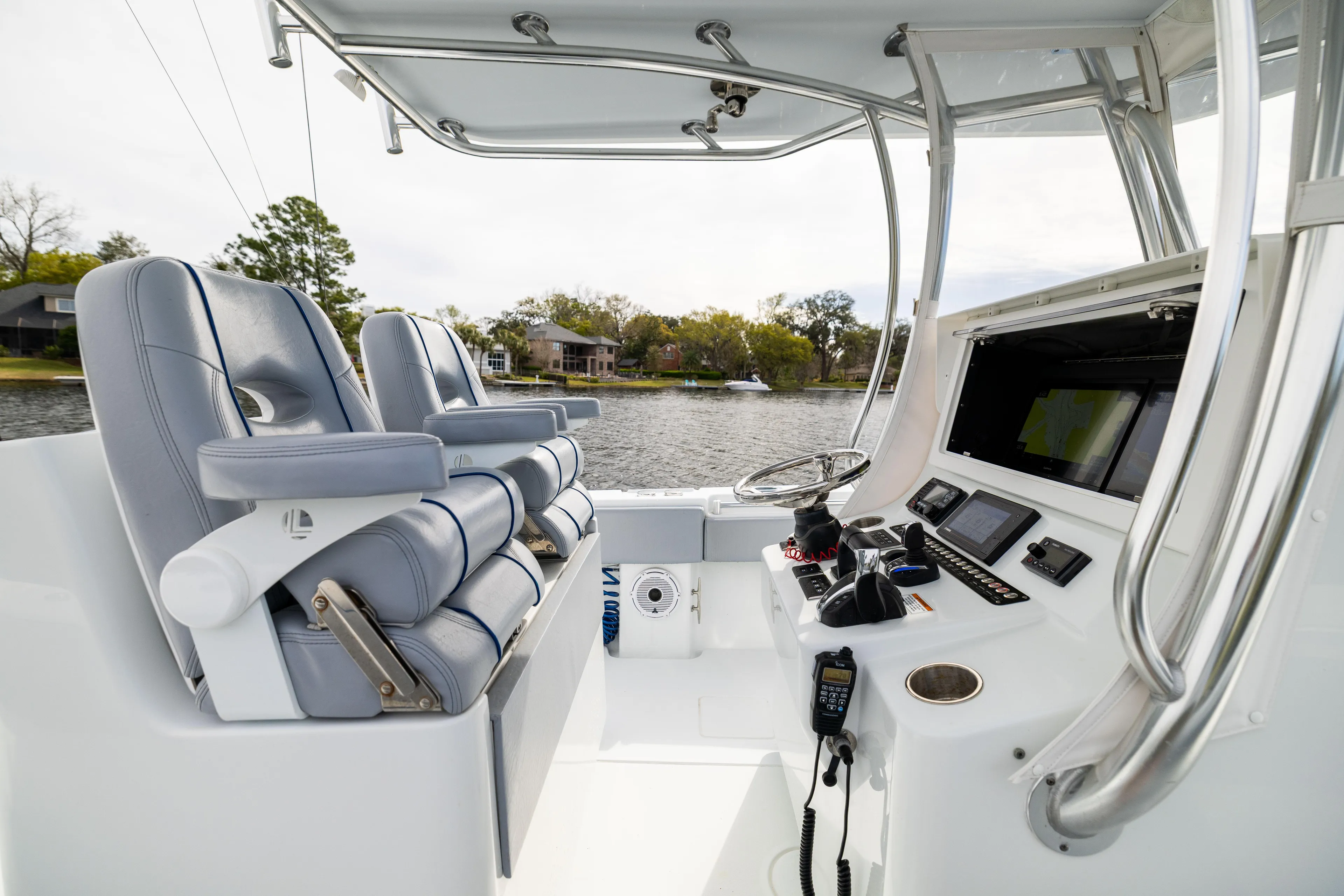  Yacht Photos Pics 2022 Contender 35ST boat interior with dual seats and advanced navigation controls.