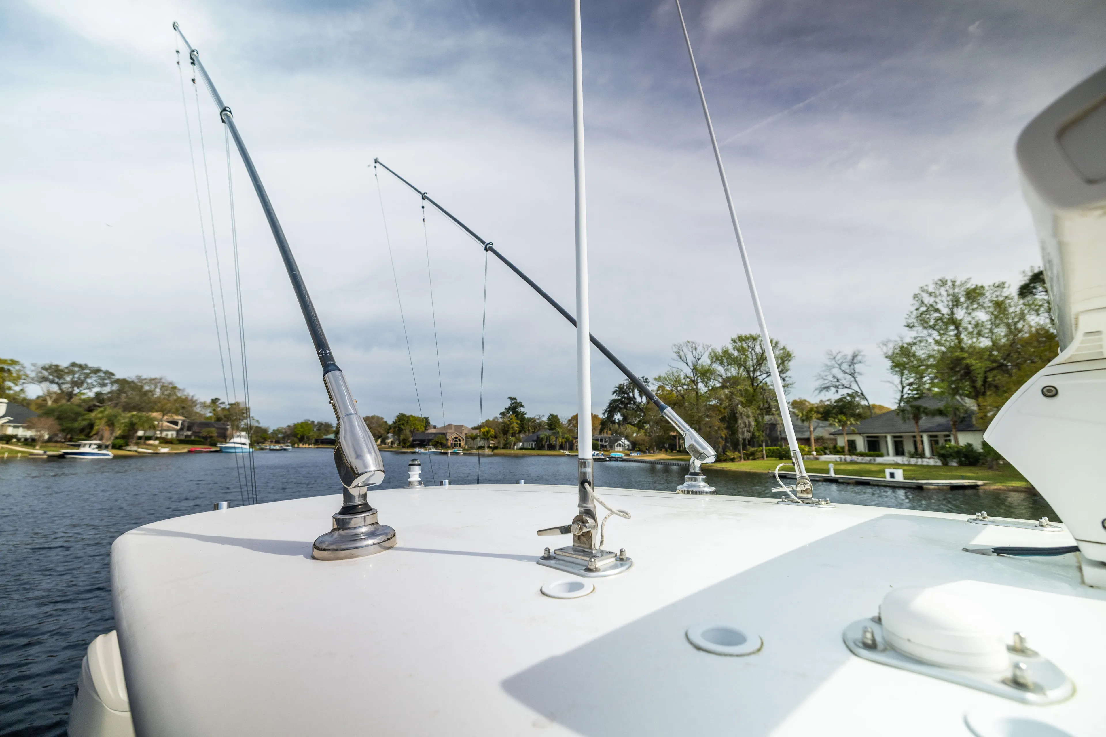  Yacht Photos Pics 2022 Contender 35ST boat with fishing rods on a calm river.