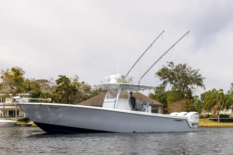  Yacht Photos Pics 2022 Contender 35ST boat on water, featuring sleek design and fishing rods.