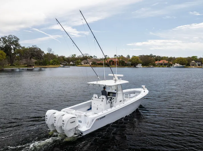  Yacht Photos Pics 2022 Contender 35ST boat cruising on a calm lake with dual outboard engines.