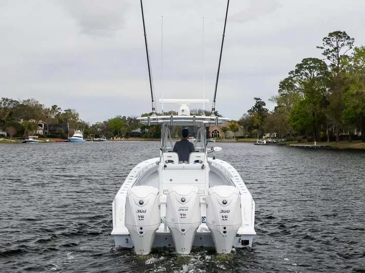  Yacht Photos Pics 2022 Contender 35ST boat with triple 300 V6 engines cruising on a calm river.